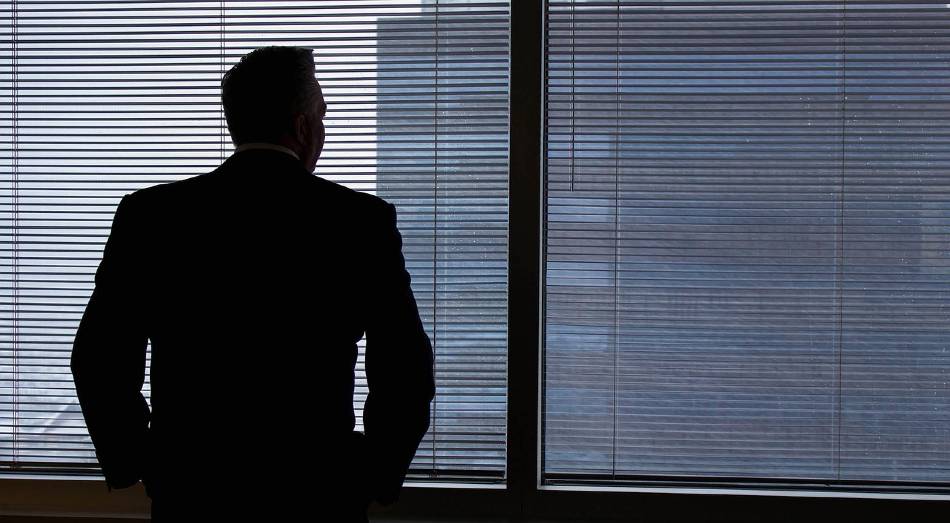 executive looking out window