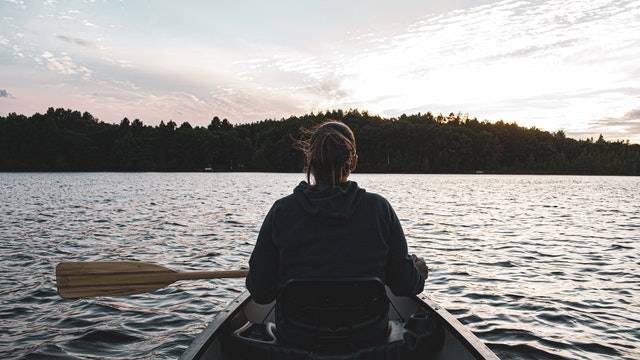 Woman kayaking on lake